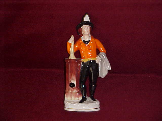 Figure of fireman with horn. 9 1/4" tall.