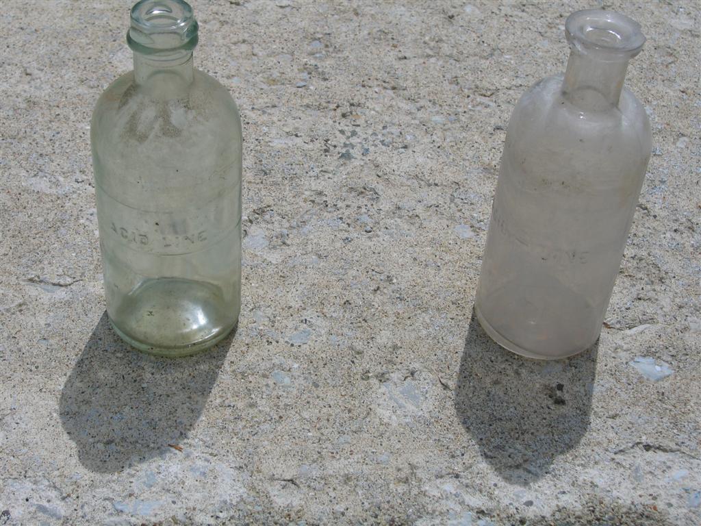 Two Glass Acid Bottles. Each are 6 inches high x