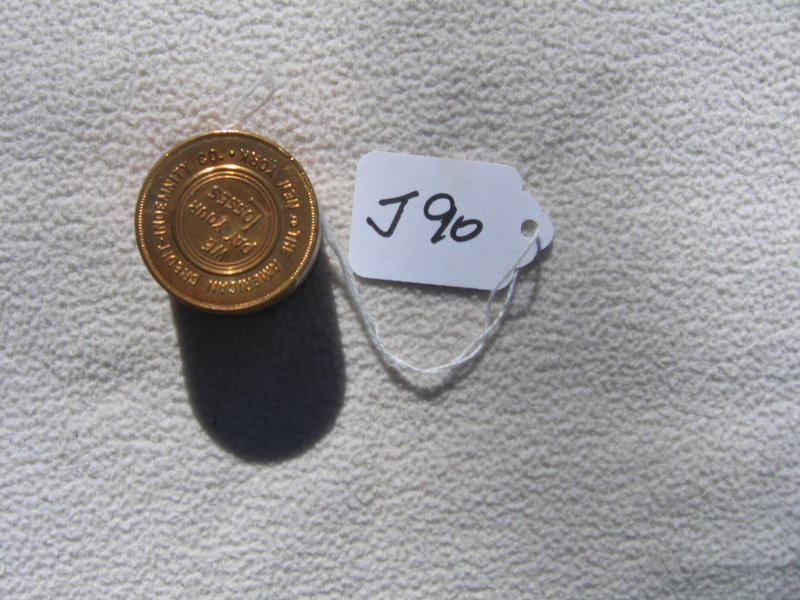 Stack of "Gold Coins". Both top and bottom says T