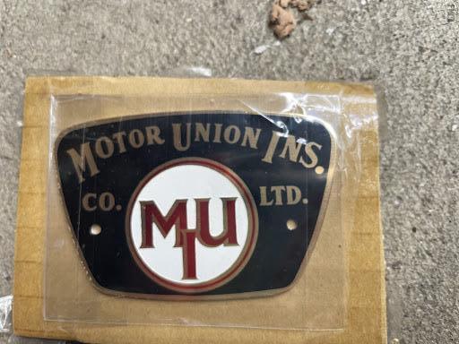 #105 Motor Union Ins. Co. Ltd. Auto Tag. 2 ½ by 1 ¾ inches.