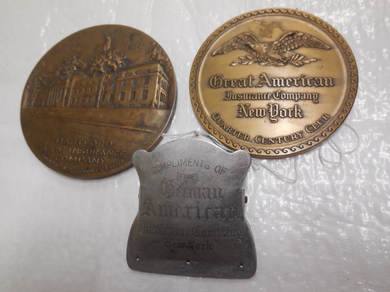 2 paperweights - Great American Insurance and Hartford Fire, plus a German American paper clip.