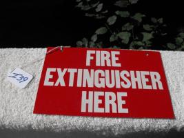 Fire Extinguisher Here Sign. Same thing written o