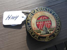 Maryland Casualty metal paperweight. 2 1/4 diamet