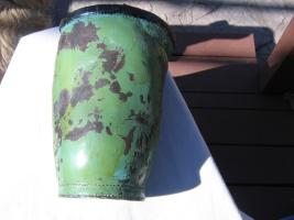 Fire Bucket. Green Paint that has peeled off in m